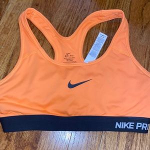 Orange Nike pro sports bra and a size small